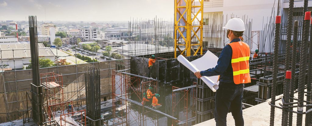 Smart civil architect engineer inspecting and working outdoors b